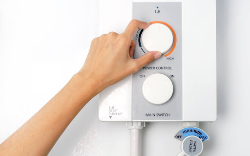 Homeowner changing water heater temperature.